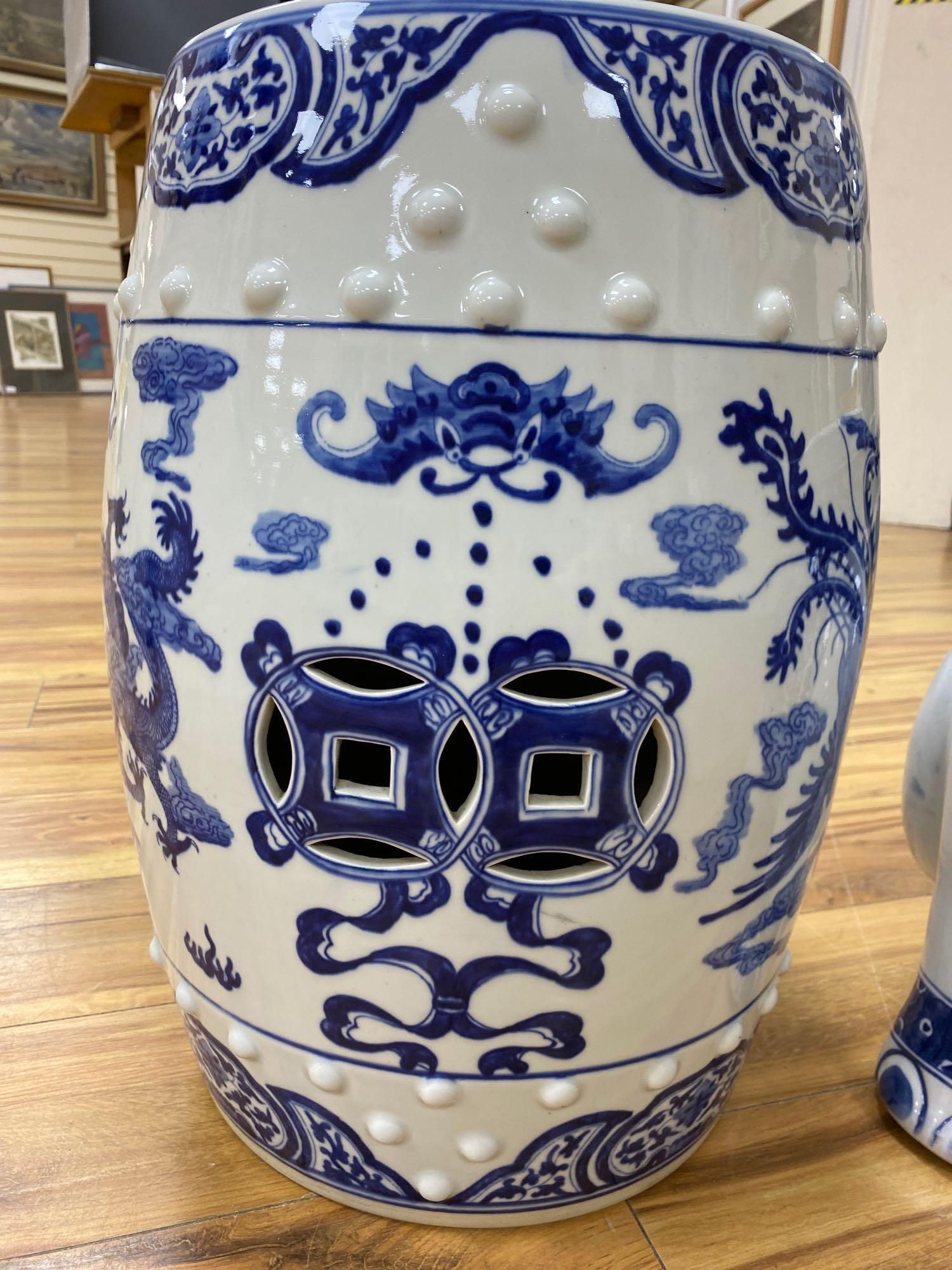 A Chinese blue and white ceramic garden seat and a similar elephant seat, 47.5cm tall